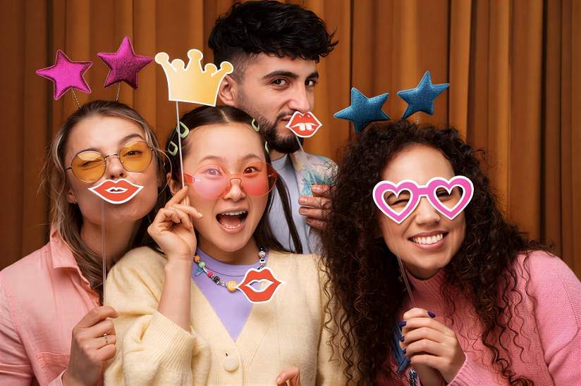 Friends laughing with photo booth props